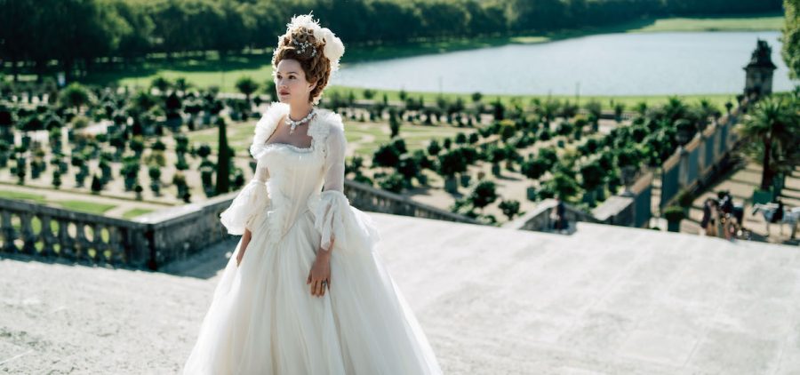 Emilia Schüle as Marie Antoinette, in wedding dress is ornate gardens