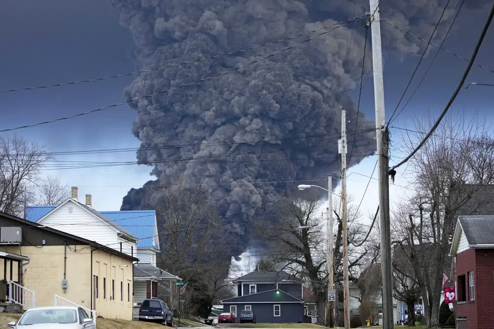A smoke plume rises over houses in East Palestine, Ohio.