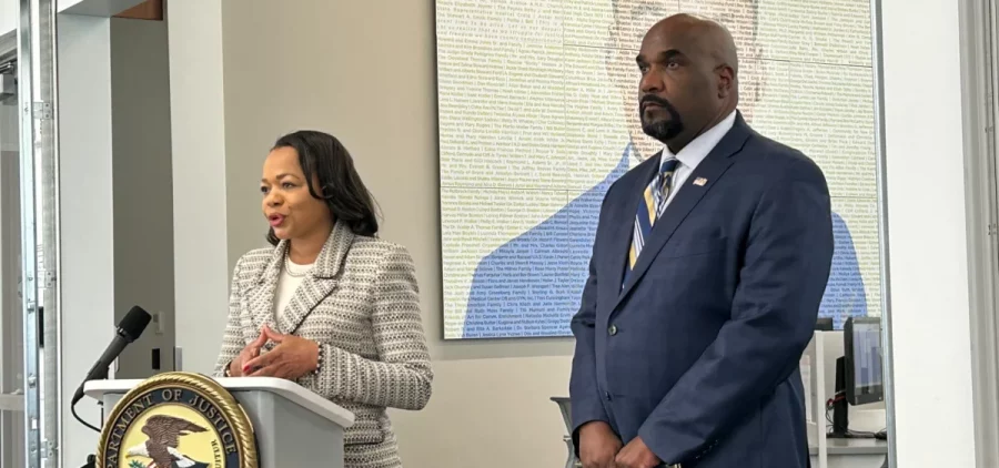 Kristen Clarke, Assistant Atty General, Dept of Justice, Civil Rights Division stands next to U.S. Attorney at a press conference.