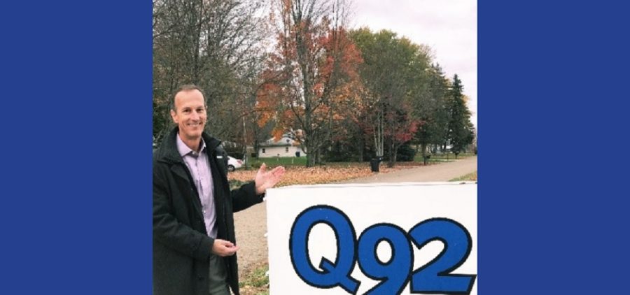 Mark O'Brien in front of radio station sign