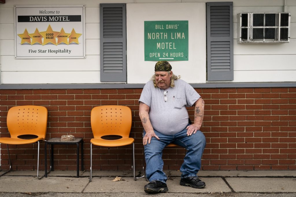 Jeff Drummond, who now resides in a motel after being displaced by the East Palestine train derailment sits outside his room in North Lima, Ohio, on Monday, April 3.