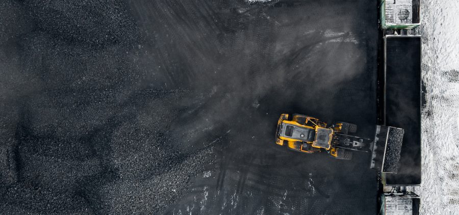Coal is loaded into a rail car at an open pit mine.