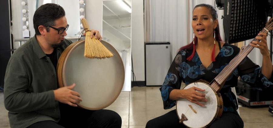 Rhiannon Giddens and Francesco Turrisi playing lap drum and banjo