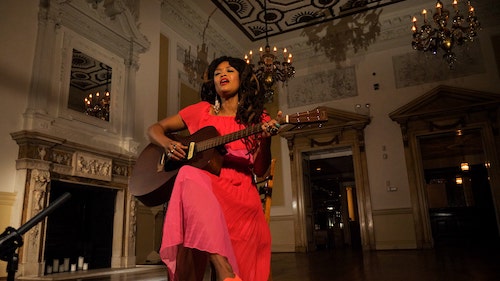 Valerie June playing guitar on screen