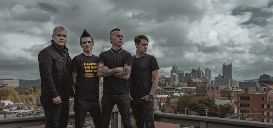 A promotional picture for Pittsburgh punk band Anti Flag. The band is on top of a building in Pittsburgh.