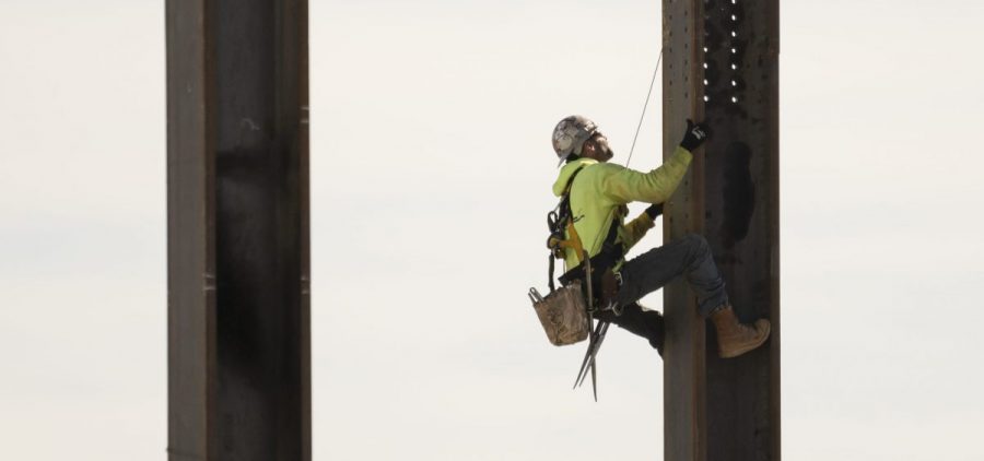 An ironworker scales a column during construction of a municipal building in Norristown, Pa.