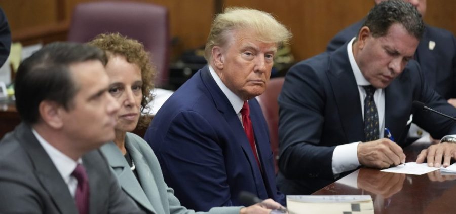 Former President Donald Trump sits with his defense team in a Manhattan court
