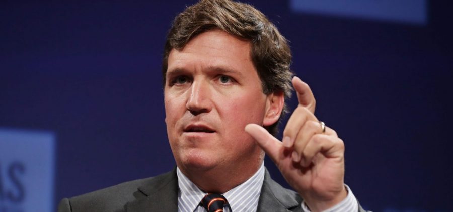Fox News host Tucker Carlson speaks at a National Review Institute event on March 29, 2019, in Washington, D.C. The network announced Monday that it would "part ways" with Carlson.