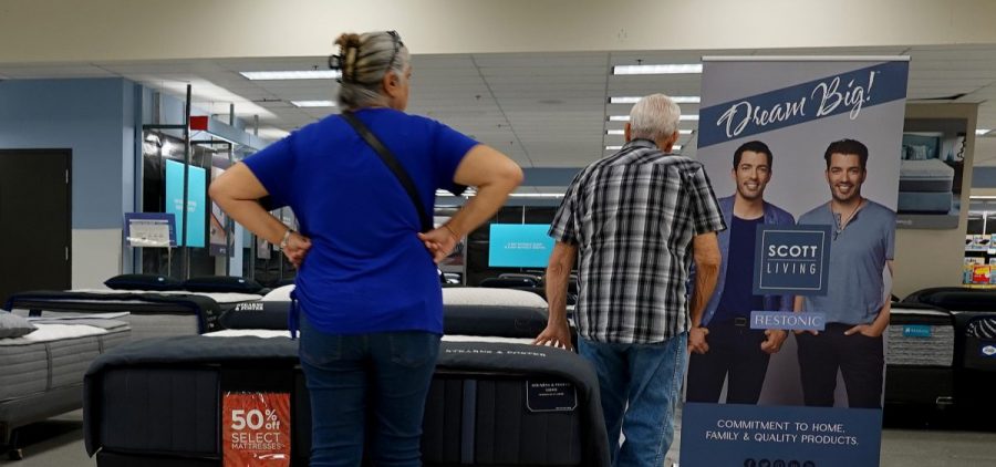 Shoppers look over mattresses at a store in Miami