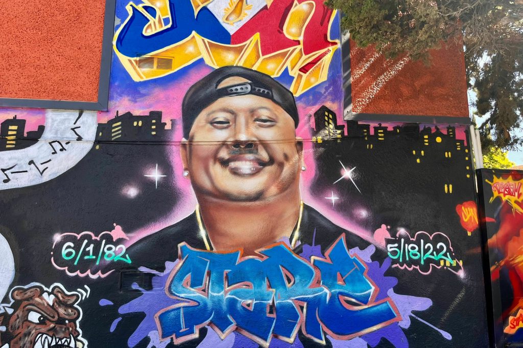 A street mural honors the life of Artgel "Jun" Anabo Jr. near where was fatally shot just outside his Lucky Three Seven restaurant in East Oakland, Calif., in May 2022. Like more than 60% of the murders in the city, his killing remains unsolved.