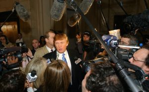 Donald Trump is greeted by the media after arriving at open auditions for the second season for his reality television show "The Apprentice" March 18, 2004, in New York. 