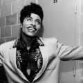 LITTLE RICHARD - US rock musician about 1958. Smiling, arms in the air in suit about 1958