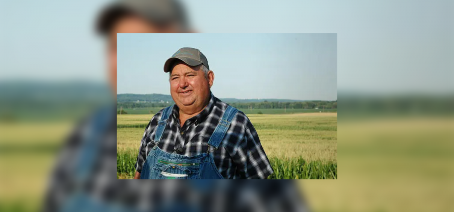 Farmer David Brandt stands in front of a crop field