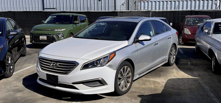 A Hyundai sedan sits in the parking lot of East Bay Tow Inc.