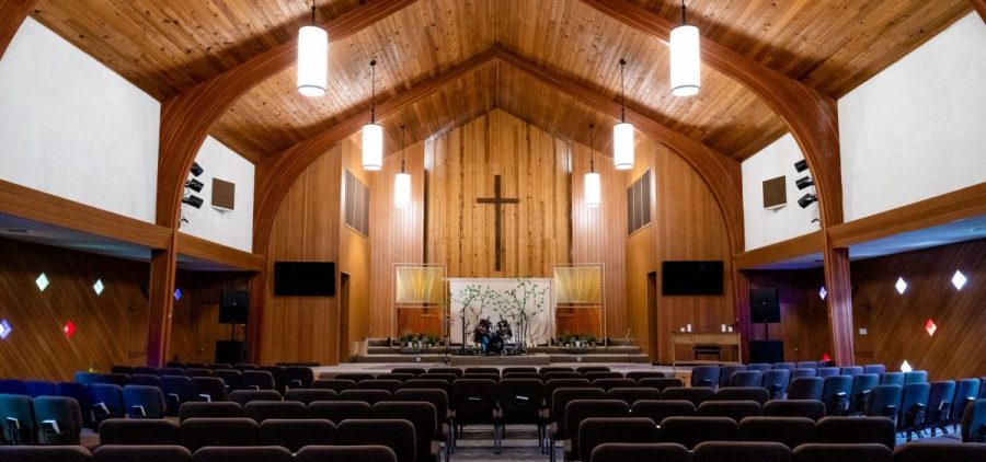 Inside the Church of the Nazarene with wooden walls and high arched ceilings.