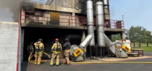Firefighters from Madison Township in Franklin County prepare to train on battling a blaze inside a structure on the campus of the State Fire Marshal in Reynoldsburg east of Columbus.