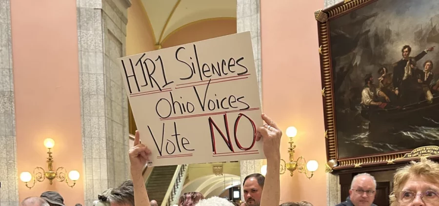 A homemade sign reads HJR1 Silences Ohio Voices Vote No as protestors oppose the resolution in the state capitol