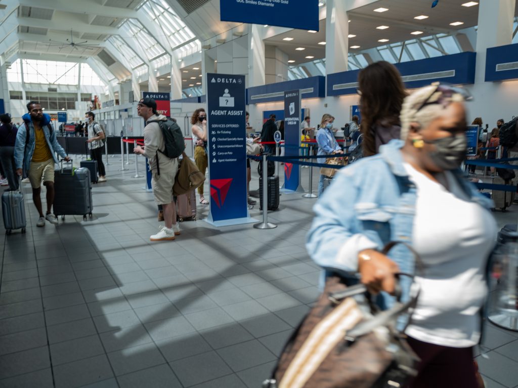 People travel through the terminal at John F. Kennedy Airport at the start of the Memorial Day weekend on May 27, 2022 in New York City.