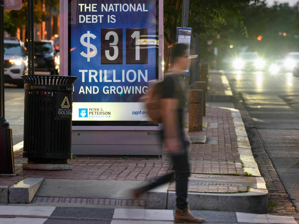 A poster at a bus shelter in Washington, D.C., on May 21 shows the national debt.