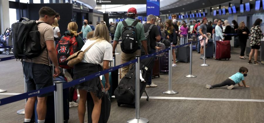 Travelers line up to check in for United Airlines flights at San Francisco International Airport on July 1, 2022 in San Francisco, Calif.
