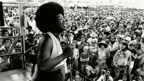 Irma Thomas on stage performing for massive crowd