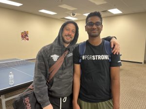 Gaelan Mullins, the founder of Hot Shot Table Tennis, smiles with his first Athens league champion, Pranay Byreddy.