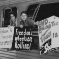 1960's Freedom Riders holding protest signs out window of bus