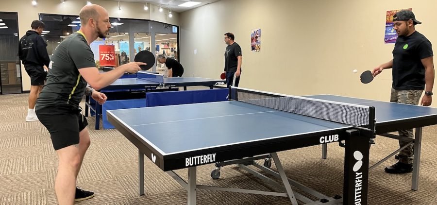 Gaelan Mullins, the founder of Hot Shot Table Tennis, warms up with another player before their first league competition. Mullins says he has been playing table tennis for as long as he can remember.