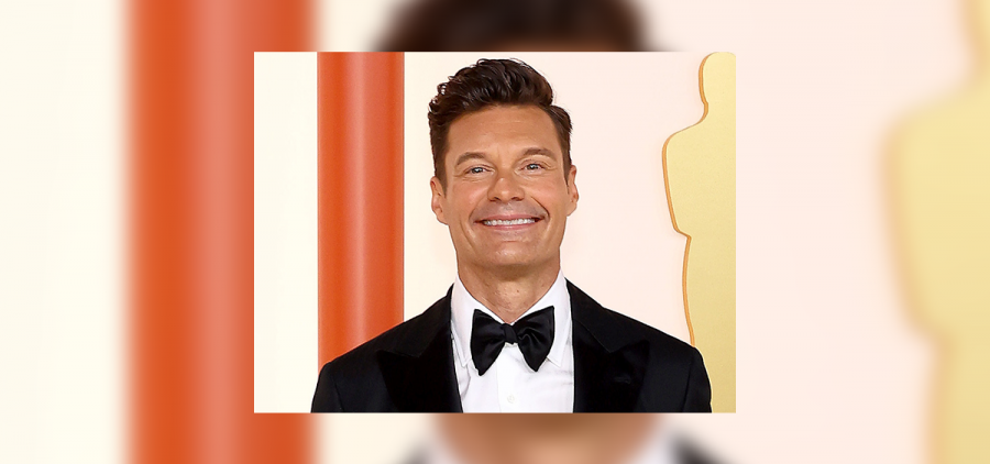 Ryan Seacrest poses for a picture on the red carpet at the Oscars