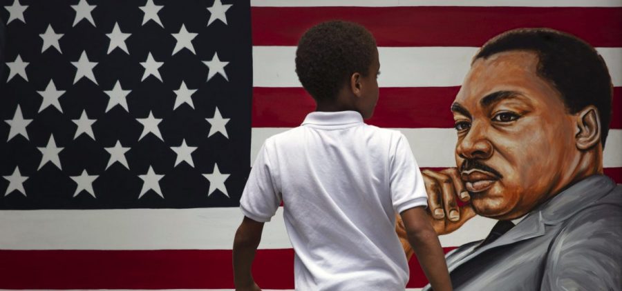 A young boy walks past a painting depicting Dr. Martin Luther King Jr. during a Juneteenth celebration in Los Angeles in 2020.