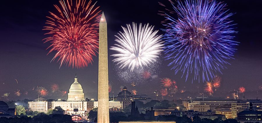 Fireworks over Washington DC, washington monument and capital in foreground with city behind