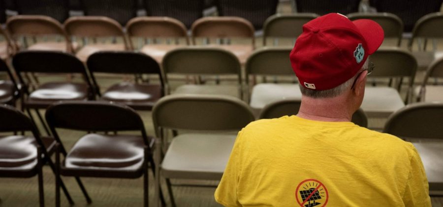 A person waits as people gather for a meeting of the Mid Missouri Landowner Alliance, to discuss opposition to solar farm projects in the Callaway County area, in New Bloomfield, Missouri, on March 15, 2023