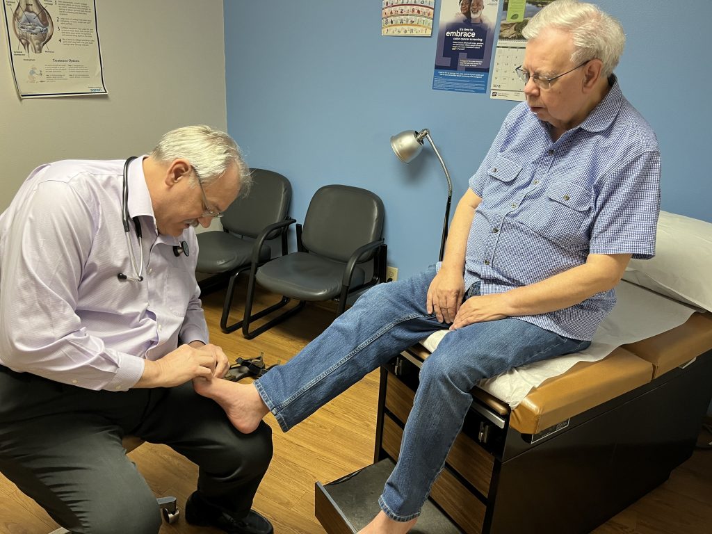 Osteopathic physician Kevin de Regnier of Winterset, Iowa, checks the feet of Ben Turner, a local pastor who has diabetes.