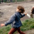 Girl throwing bottles at British troops during a riot in Belfast, Northern Ireland, in 1981.