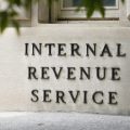 An Internal Revenue Service sign outside of an IRS building.