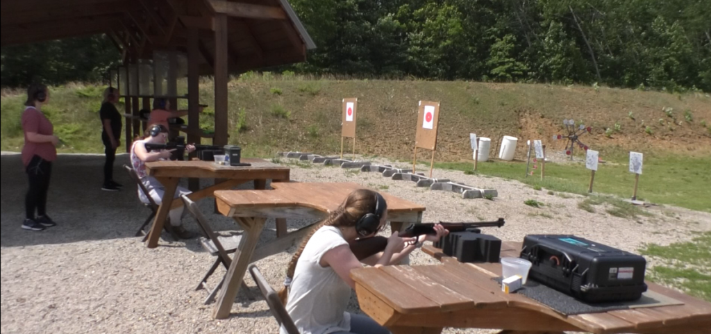 Judi Phelps teaching camp attendees how to properly shoot a gun.