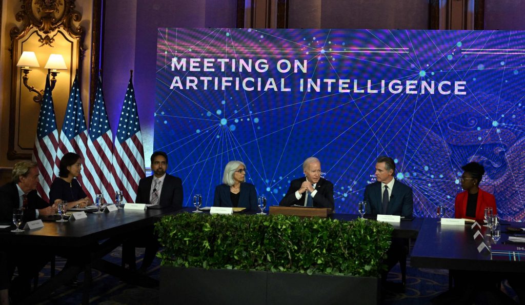 President Joe Biden sits at a panel for a meeting on artificial intelligence.