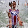 a child plays in a waterfall feature at Yards Park in Washington, D.C., on June 26.
