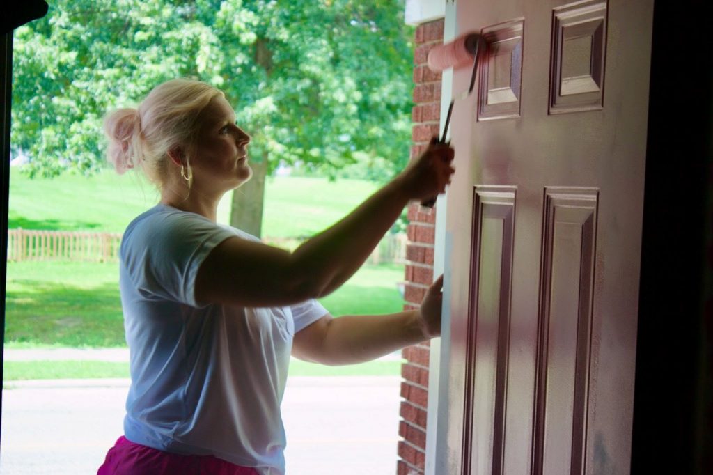Katelyn Hanes paints a door pink