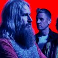 A promotional image of Mastodon, a heavy metal band. The picture is edited so that the four band members are slightly blue in color, with a very red background.