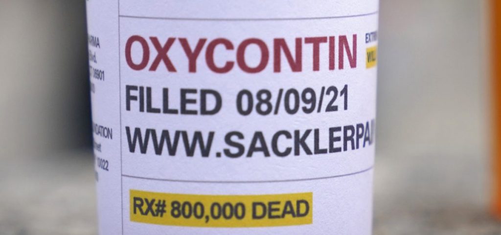 Fake pill bottles with messages about OxyContin maker Purdue Pharma were displayed during a protest outside the courthouse where the bankruptcy of the company was taking place in White Plains, N.Y. in 2021.