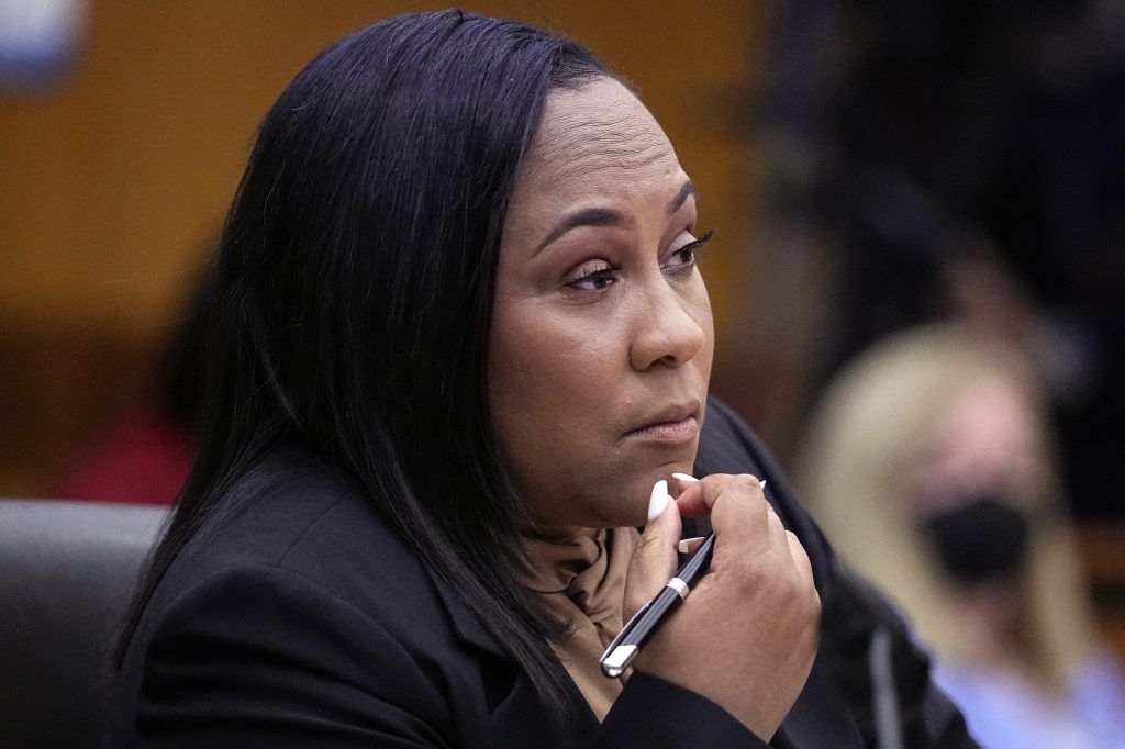 Fulton County District Attorney Fani Willis watches proceedings during a Jan. 24 hearing to decide if the final report by a special grand jury looking into possible interference in the 2020 presidential election can be released.
