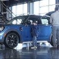 Potential buyers look at a 2023 Cooper Countryman S sports-utility vehicle on the floor of a Mini dealership