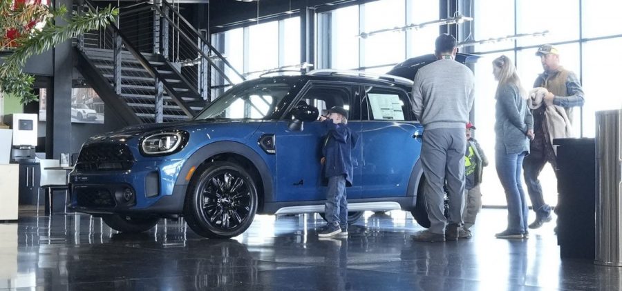 Potential buyers look at a 2023 Cooper Countryman S sports-utility vehicle on the floor of a Mini dealership