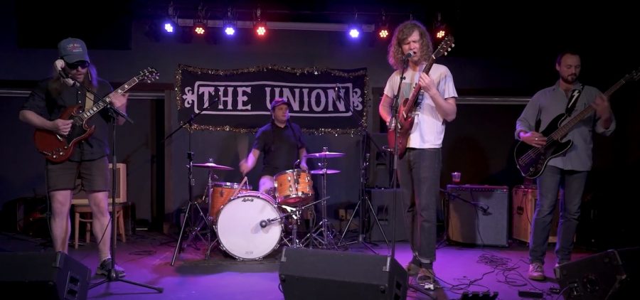 An image of the band Toecutter performing at The Union in Athens, OH for WOUB's Soundwaves. The band has four members and there are two vocalists/guitarists, a bassist, and a drummer.