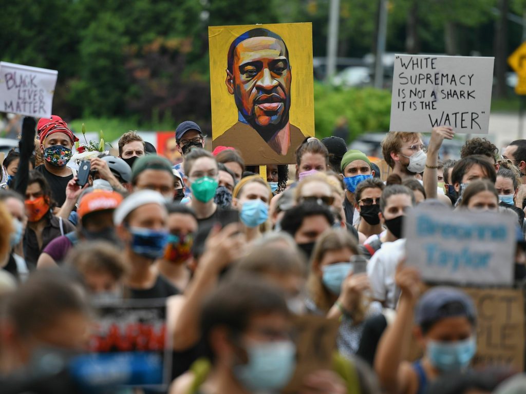 A protester holds up a portrait of George Floyd during a Black Lives Matter demonstration in Brooklyn, New York, on June 5, 2020. 