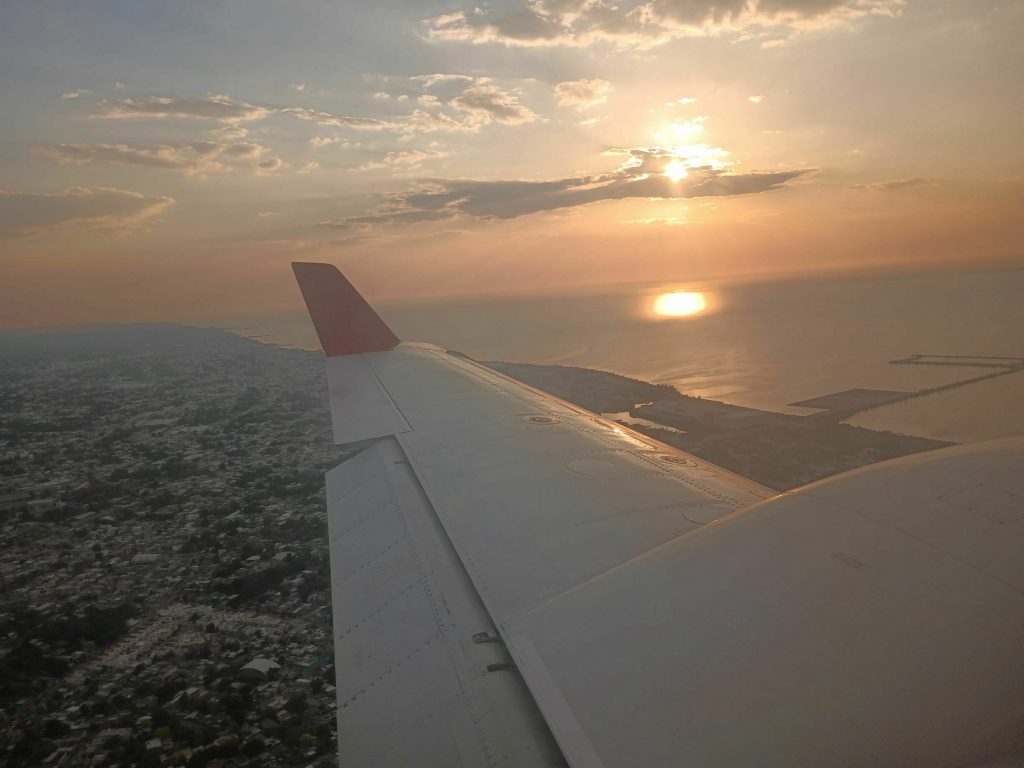 The sunset over the bay and city of Campeche, Mexico, as seen from an overwing view from a plane.