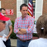 Ohio Secretary of State Frank LaRose stands surrounded by a group of Issue 1 supporters