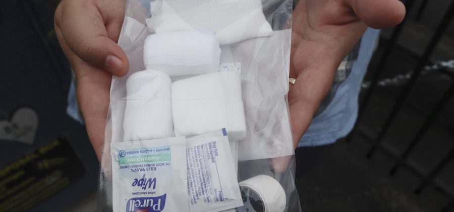 Iris Sidikman, harm reduction coordinator at the Women's Health Center of West Virginia, holds a wound care kit the clinic has on hand for intravenous drug users seeking care in the clinic parking lot in Charleston, W.Va.