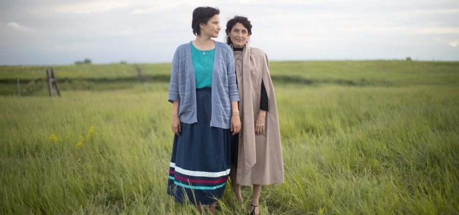 Esther (Darla Contois), Golda (Lisa Edelstein) standing in grassy field